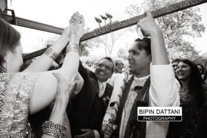 candid indian wedding photographer capturing grooms entrance in Kent