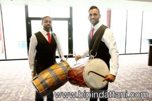 Dhol Players preparing drums for groom's entrance at wembley hilton London