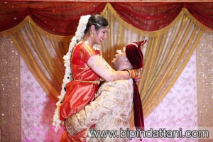 bride carried by groom after wedding captured by professional indian wedding photographer at Saffron D'or Southall UB1