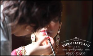 Bride getting ready with makeup artist