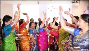 tamil wedding photoshoot of women throwing flowers for good luck
