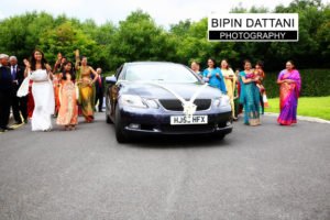 Indian groom arrival in wedding car at oshwal centre wedding