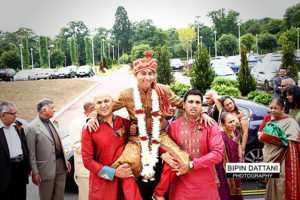 oshwal centre wedding with groom being carried on shoulders