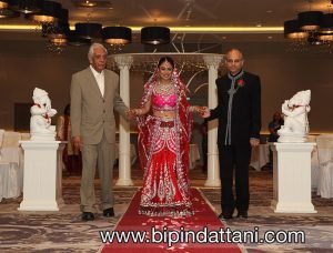 Rupa's entrance in red wedding outfit at her London Hilton Wembley wedding