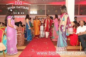 London Asian Wedding Photographer in Leicester at Platinum Suite for Nikita and Anishes Wedding ceremony. Bride's entrance with brothers